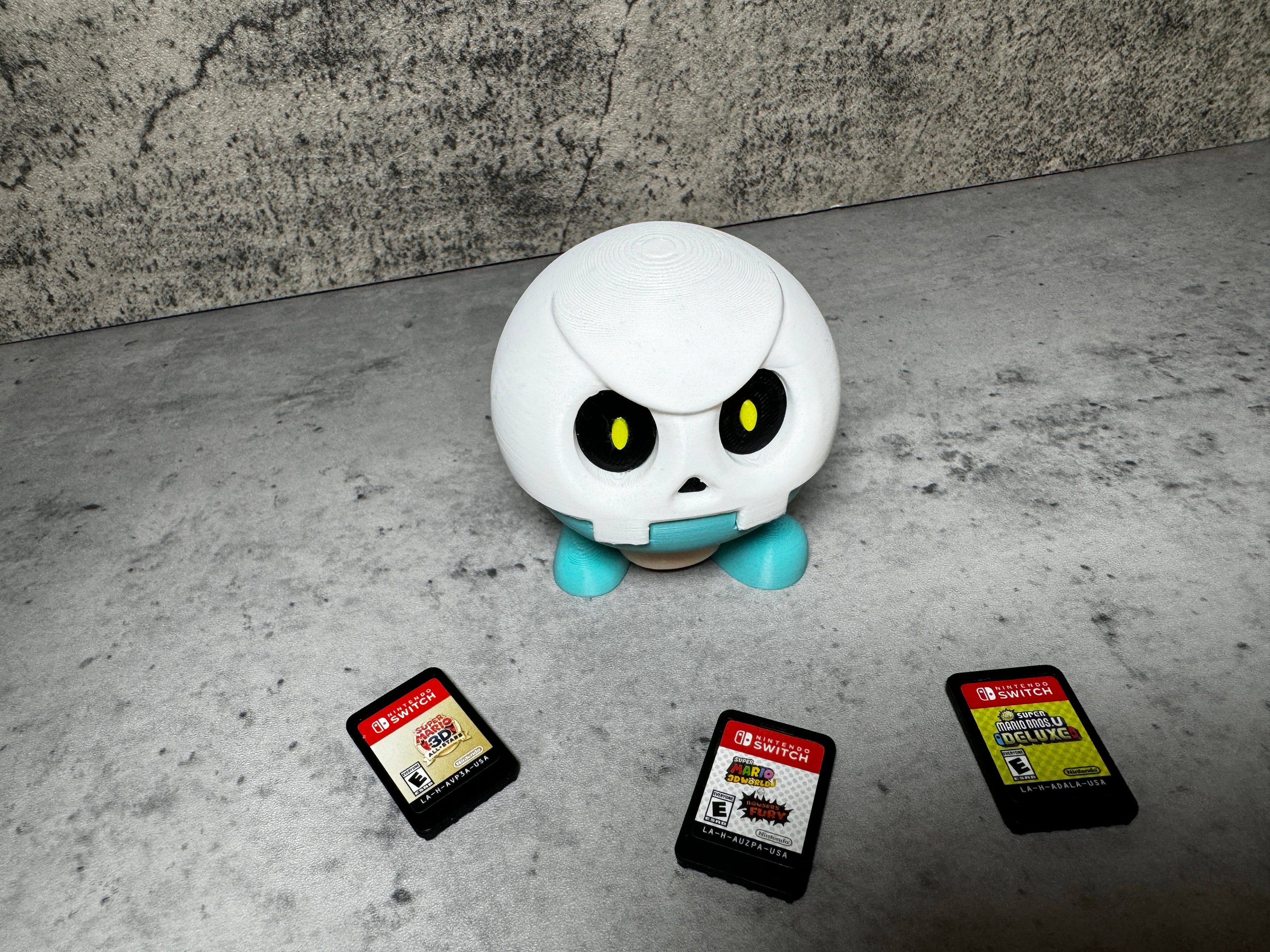 a white robot sitting next to a group of cell phones