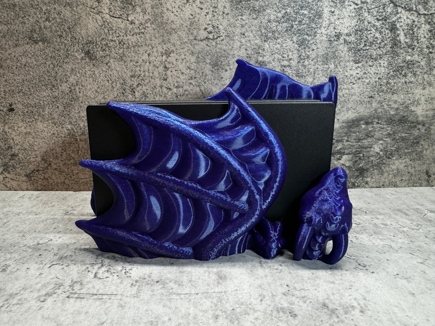 
                  
                    a blue sculpture of a dragon on a table
                  
                