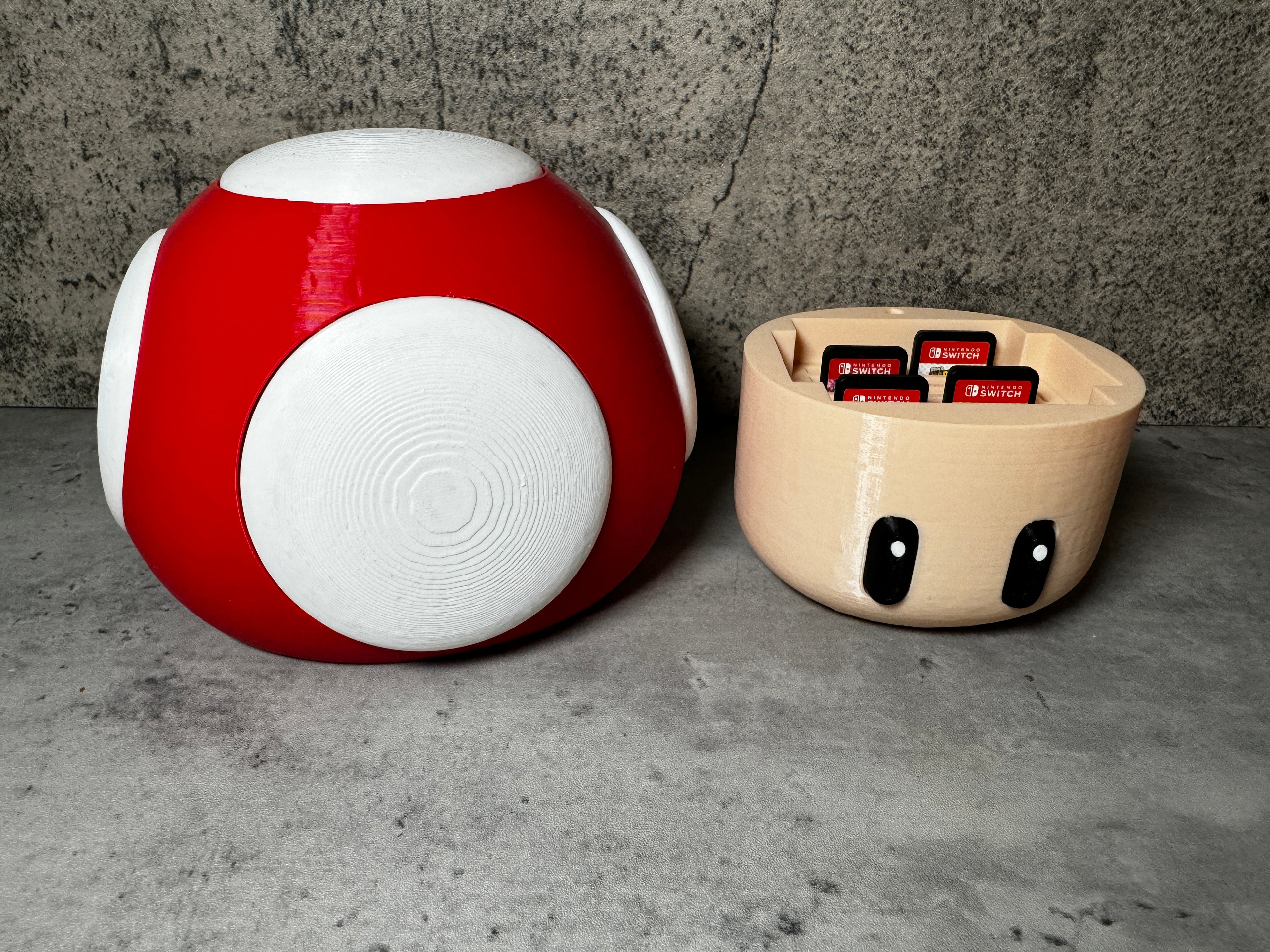 a red and white object next to a bowl of chocolates