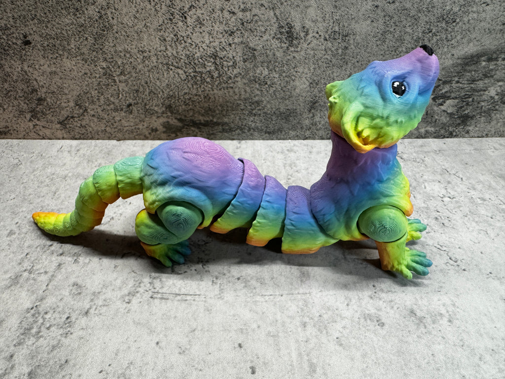 a toy lizard sitting on its side on the ground