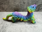 a toy lizard sitting on its side on the ground