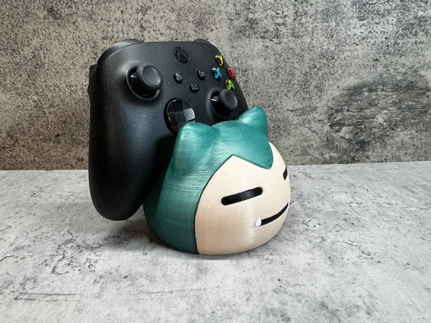 
                  
                    a close up of a controller and a figurine
                  
                