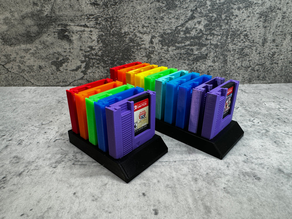 
                  
                    a set of four colorful binders sitting on top of a table
                  
                