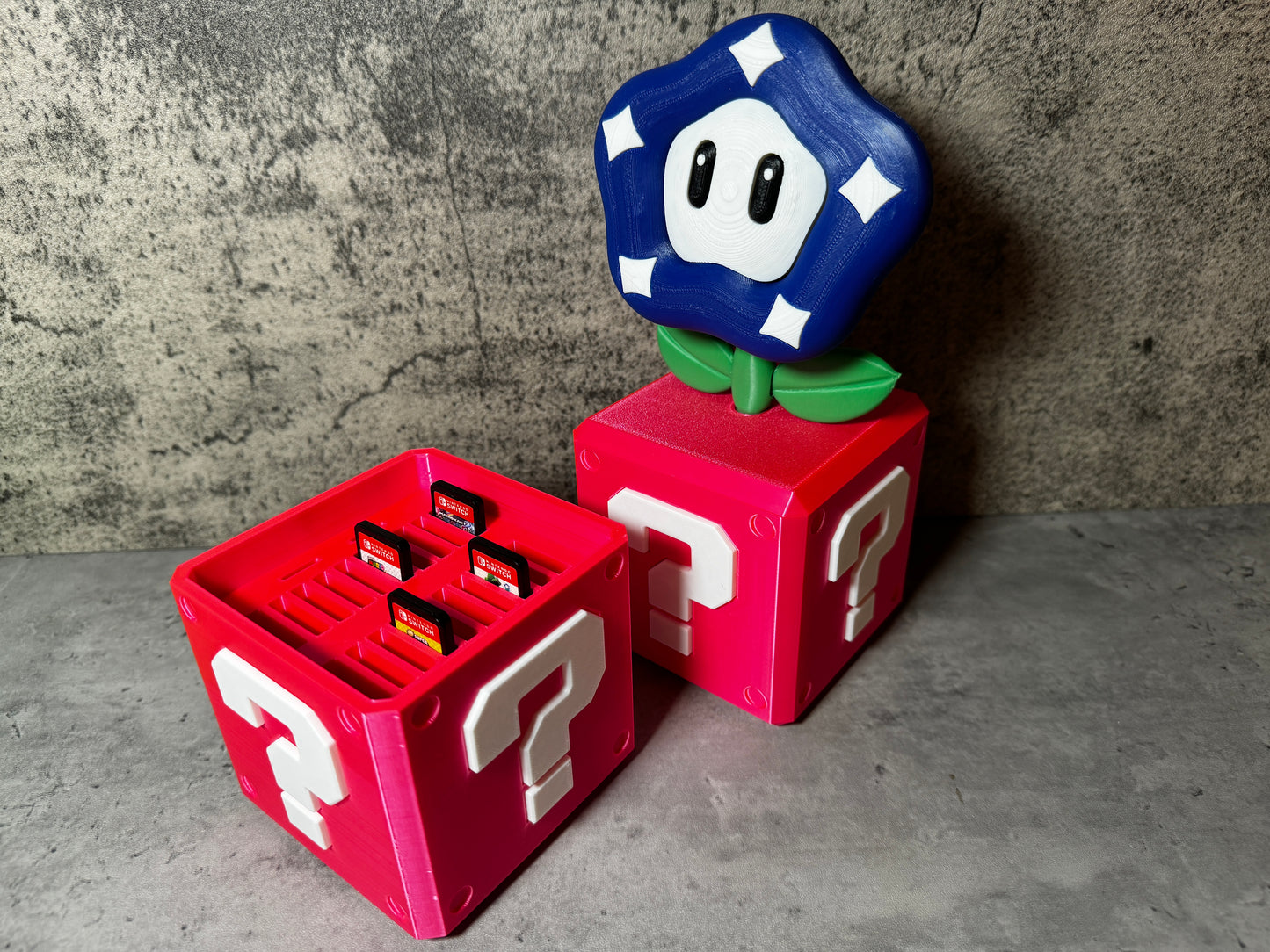 a nintendo game controller sitting on top of a red box