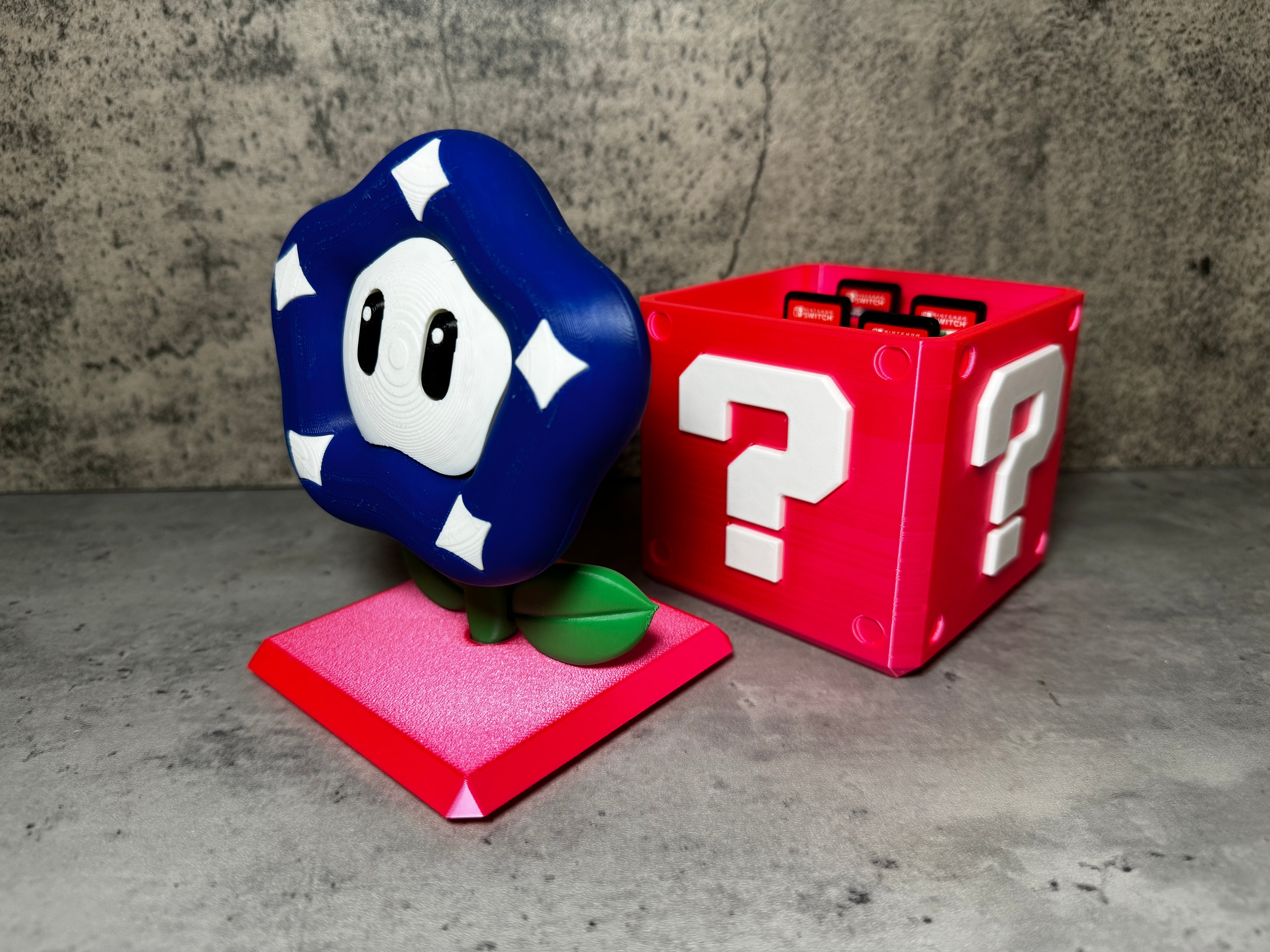 a nintendo figurine next to a red box with a question mark on it