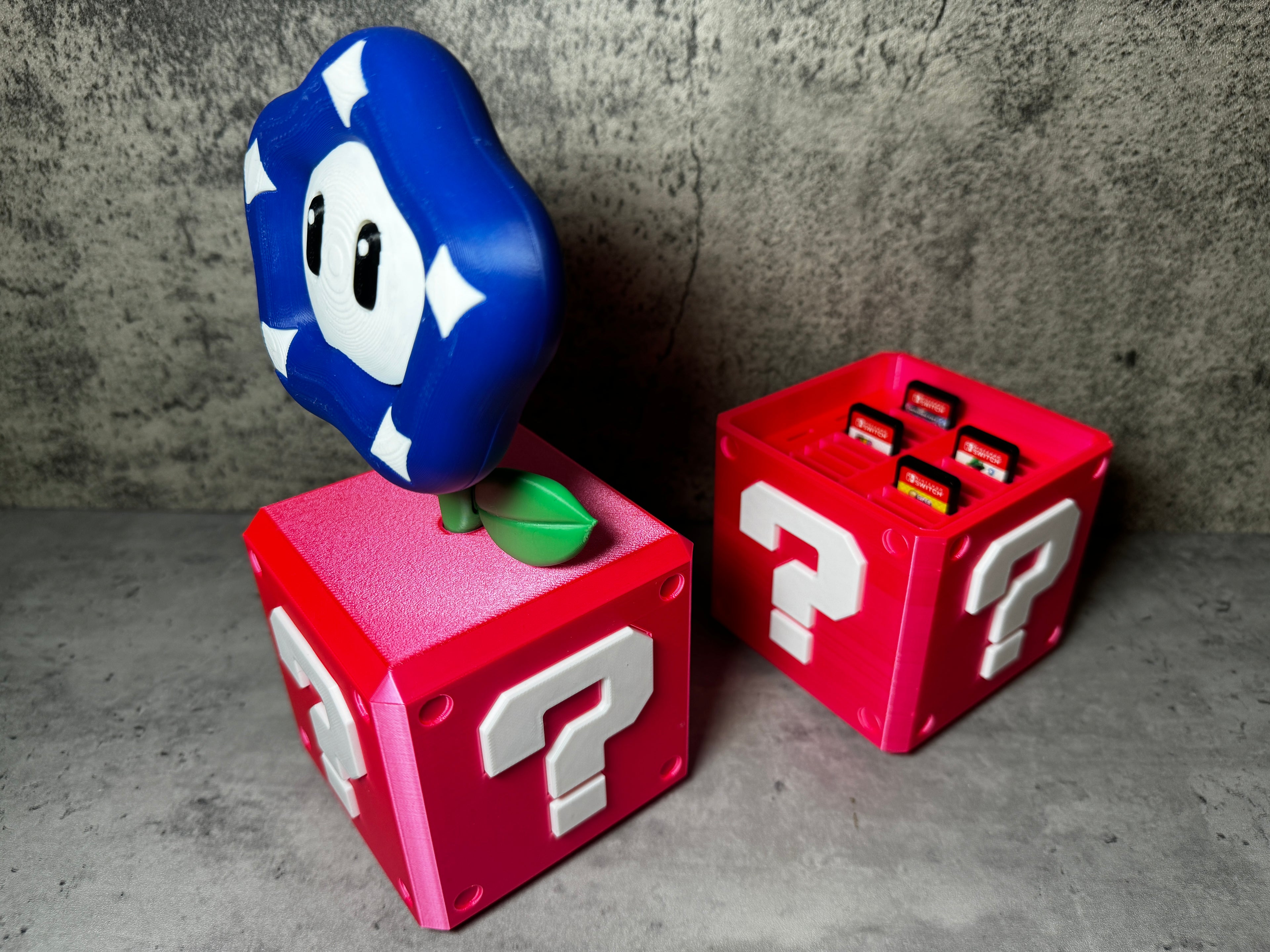 a blue and red toy sitting on top of a red box