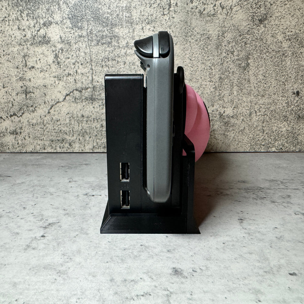 
                  
                    a cell phone that is sitting on a stand
                  
                
