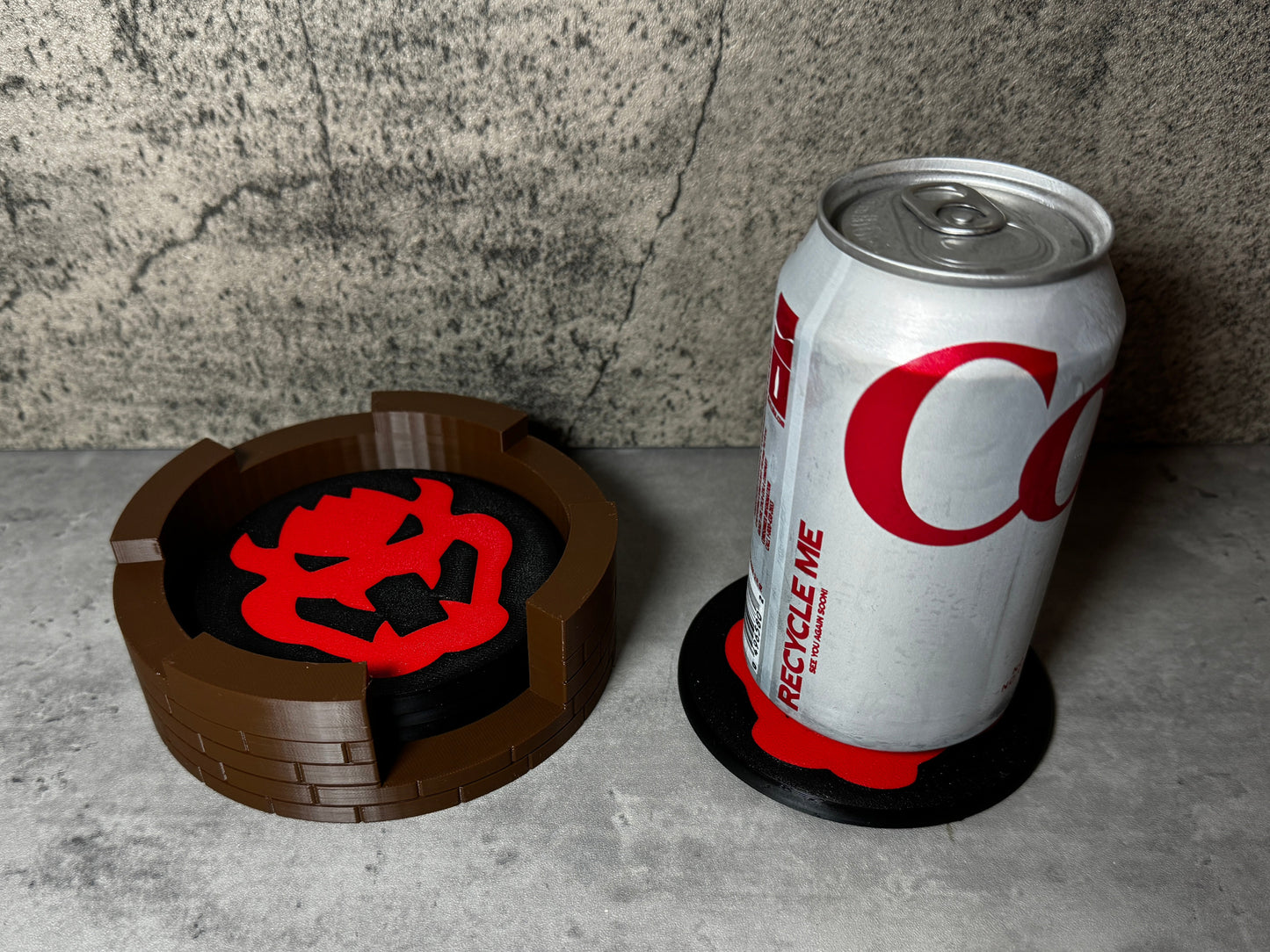 a can of coca cola next to a coaster