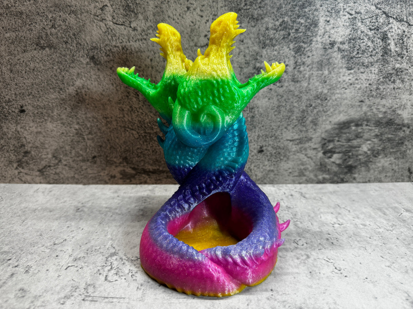 
                  
                    a colorful dragon sculpture sitting on top of a table
                  
                