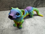a toy animal that is laying down on the ground