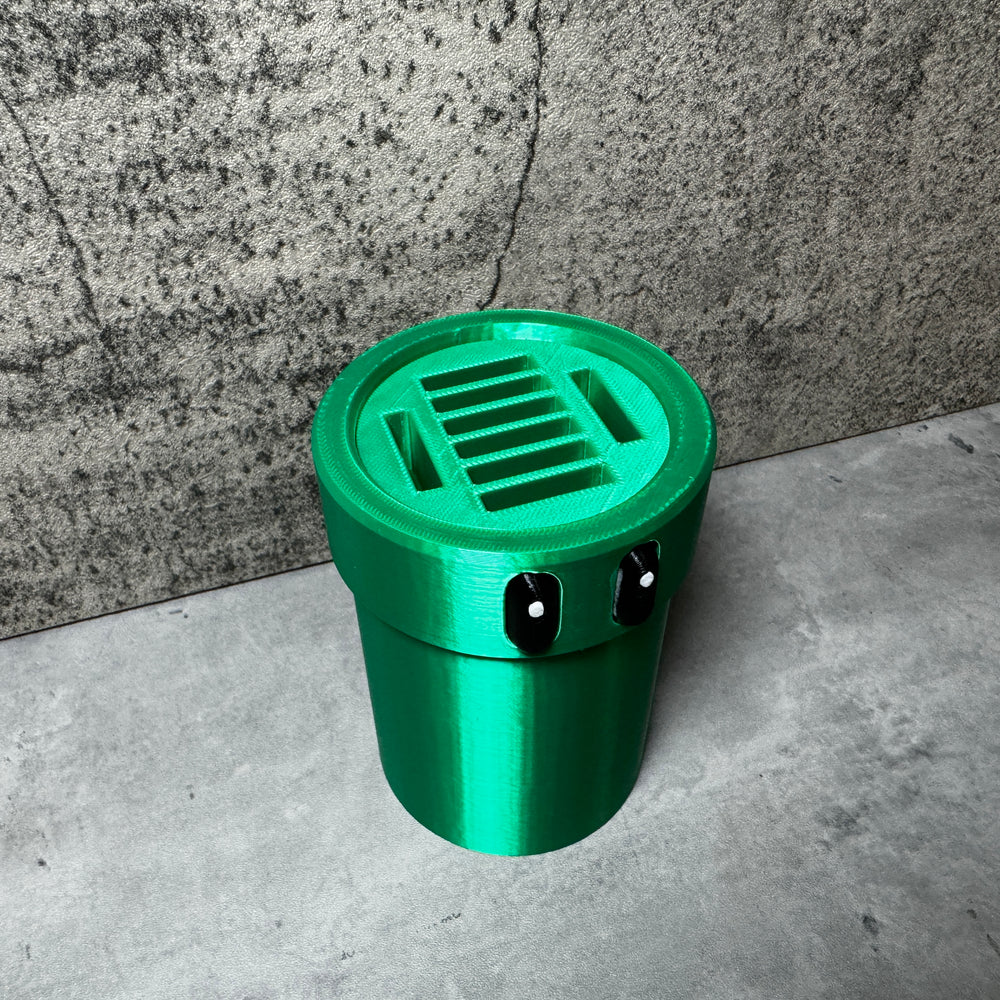 
                  
                    a green trash can sitting in front of a wall
                  
                