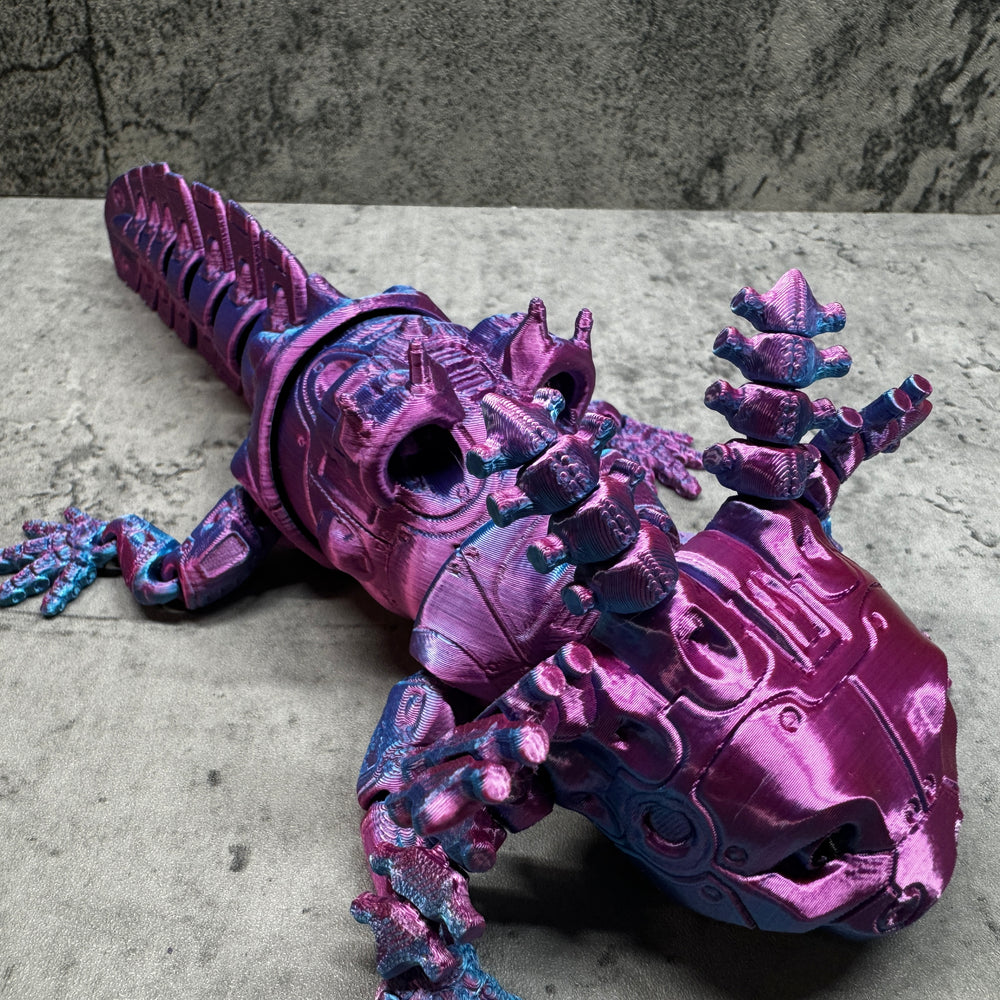 
                  
                    a purple toy lizard sitting on top of a table
                  
                