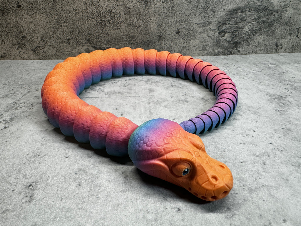 a toy snake that is laying on the ground