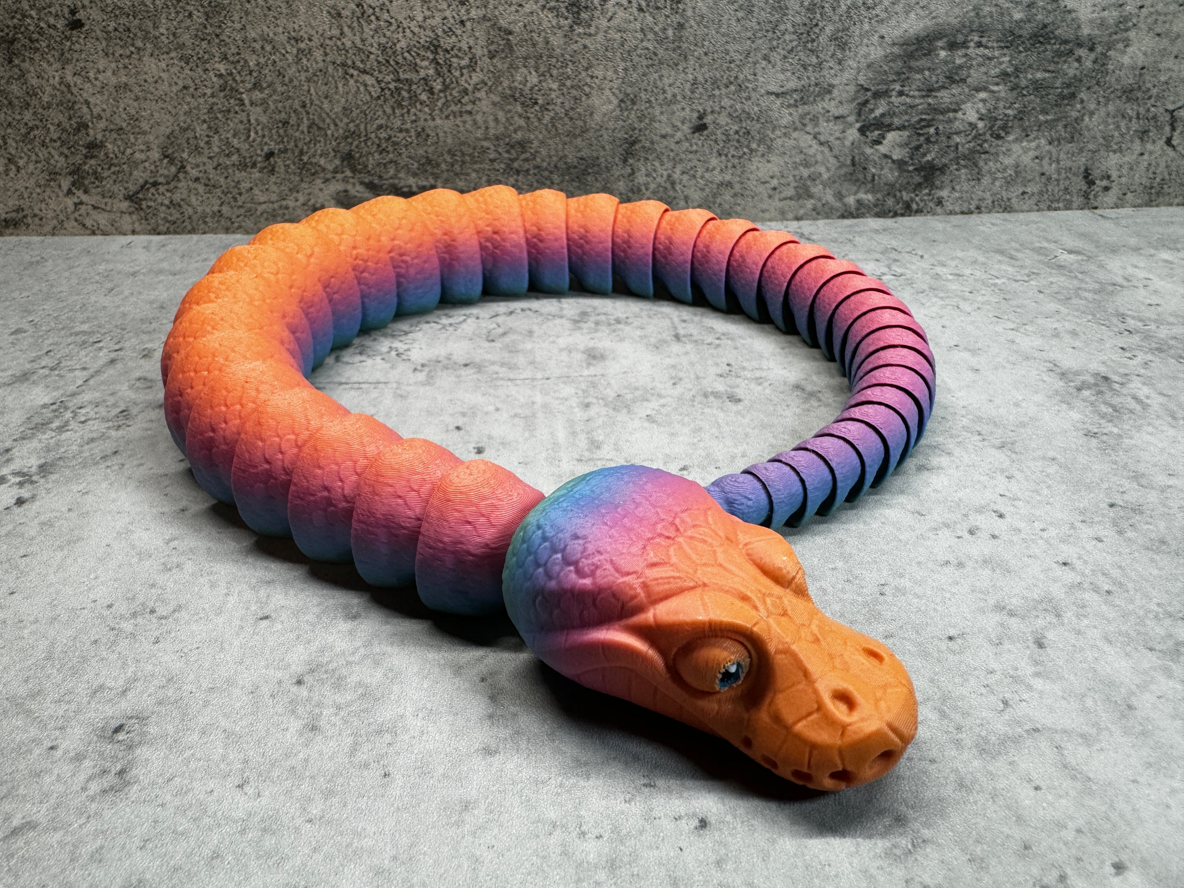a toy snake that is laying on the ground