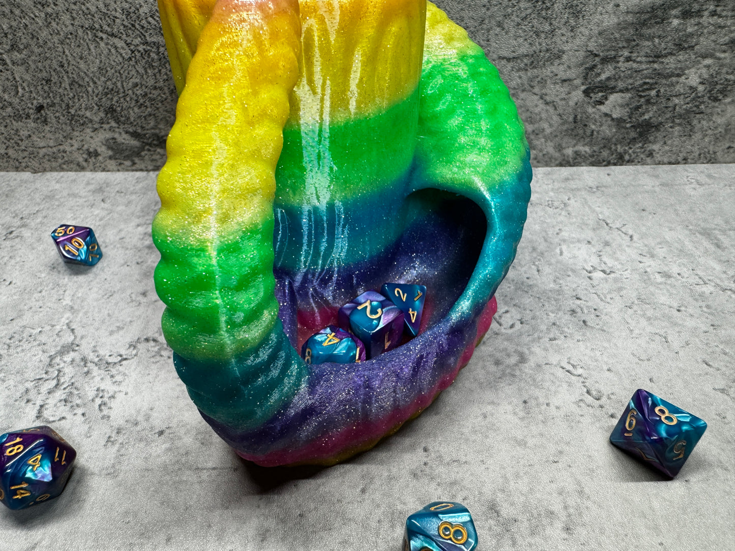
                  
                    a rainbow colored object with dice scattered around it
                  
                