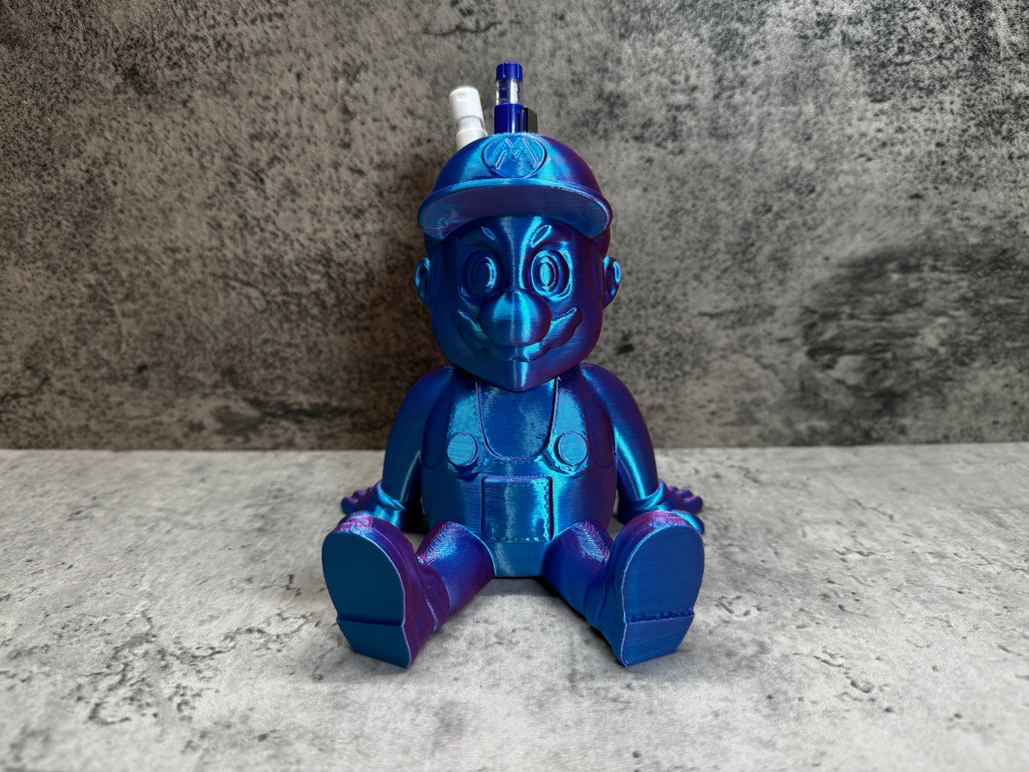 
                  
                    a blue and purple toy sitting on top of a table
                  
                