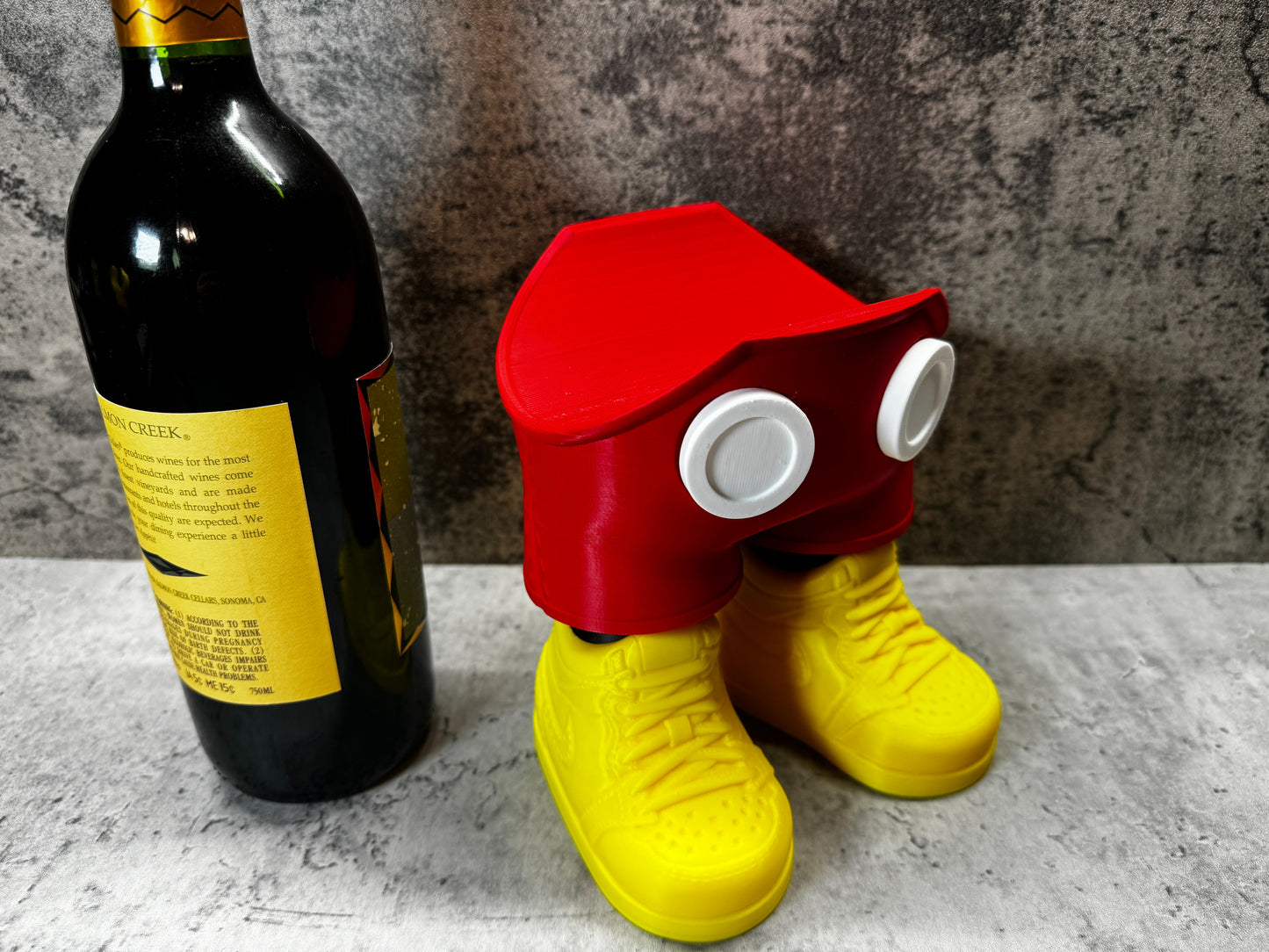 
                  
                    a bottle of wine and a pair of yellow rubber shoes
                  
                