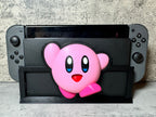 a nintendo wii game controller with a pink bear on it