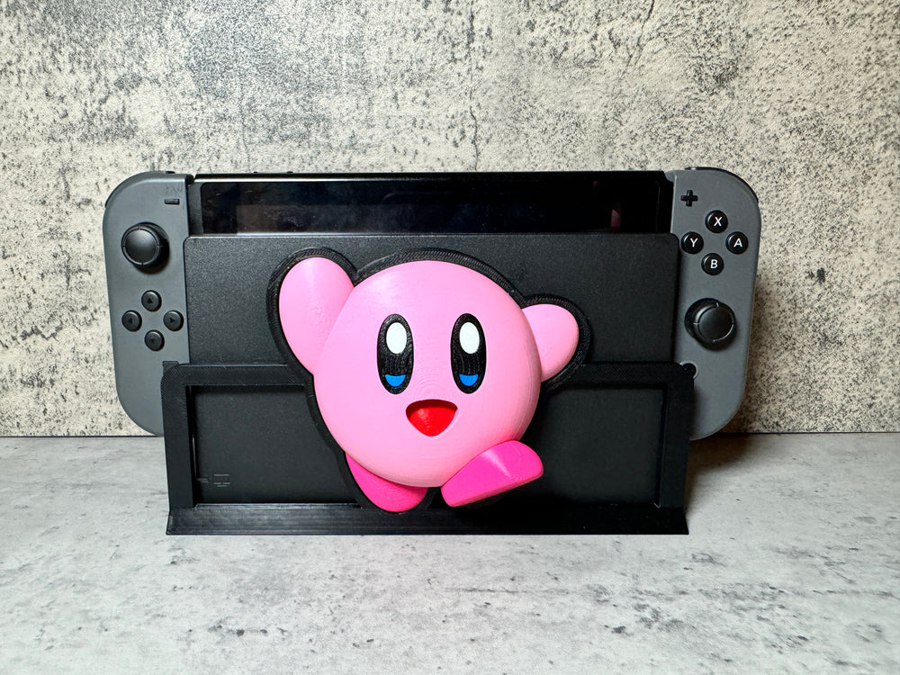 a nintendo wii game controller with a pink bear on it