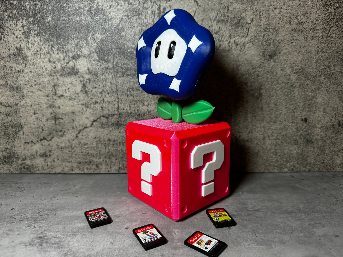 a nintendo game controller sitting on top of a red block